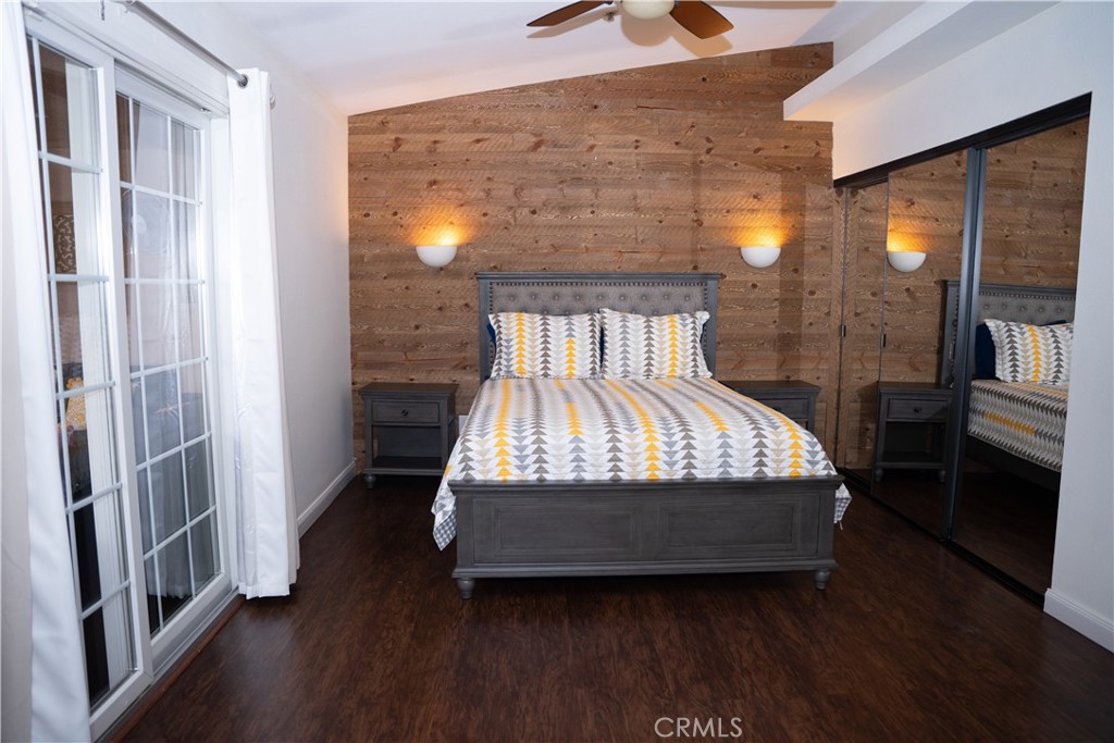 13655 El Rio Lane Desert Hot Springs, CA 92240 - Photo 19 of 27 a bedroom with a bed and wooden floor