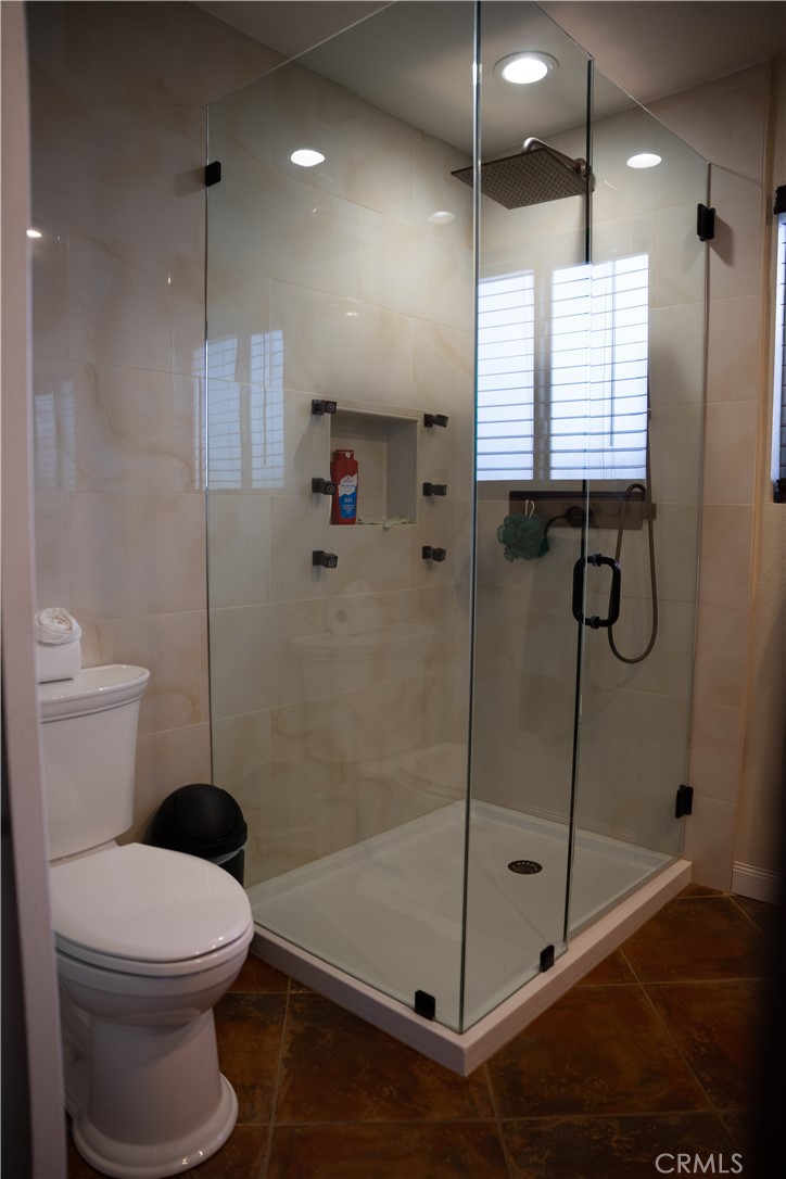 13655 El Rio Lane Desert Hot Springs, CA 92240 - Photo 22 of 27 a bathroom with a shower a toilet and a sink