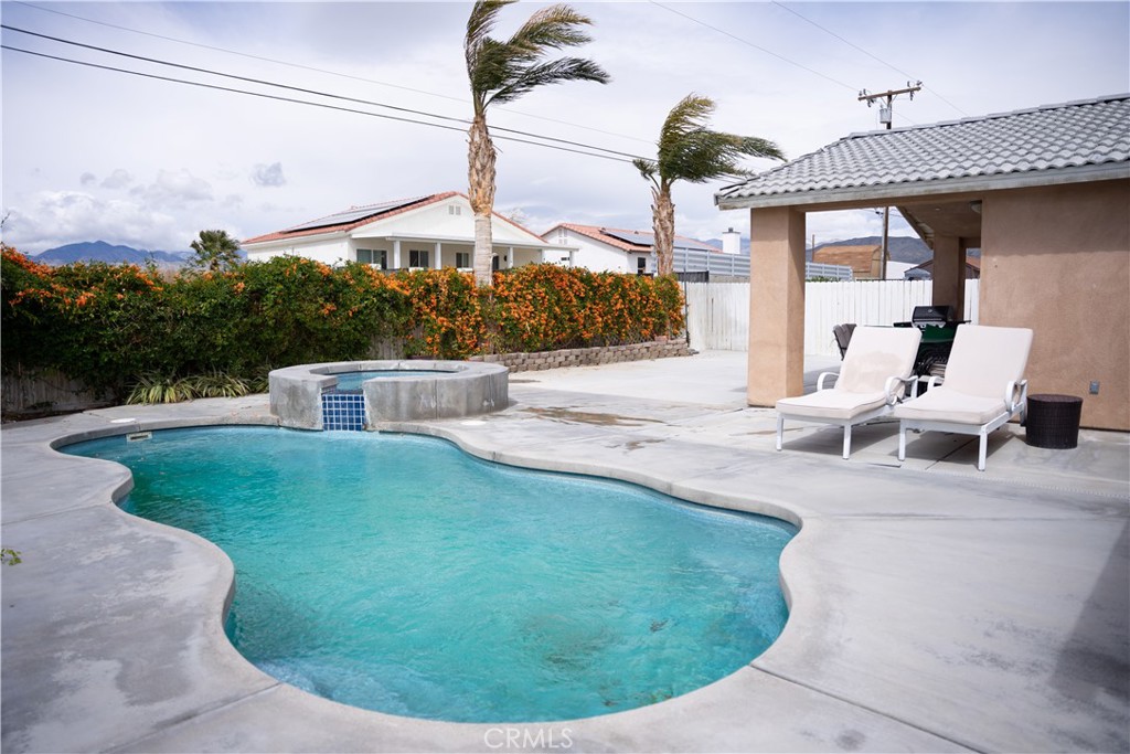 13655 El Rio Lane Desert Hot Springs, CA 92240 - Photo 23 of 27 a view of a house with a backyard