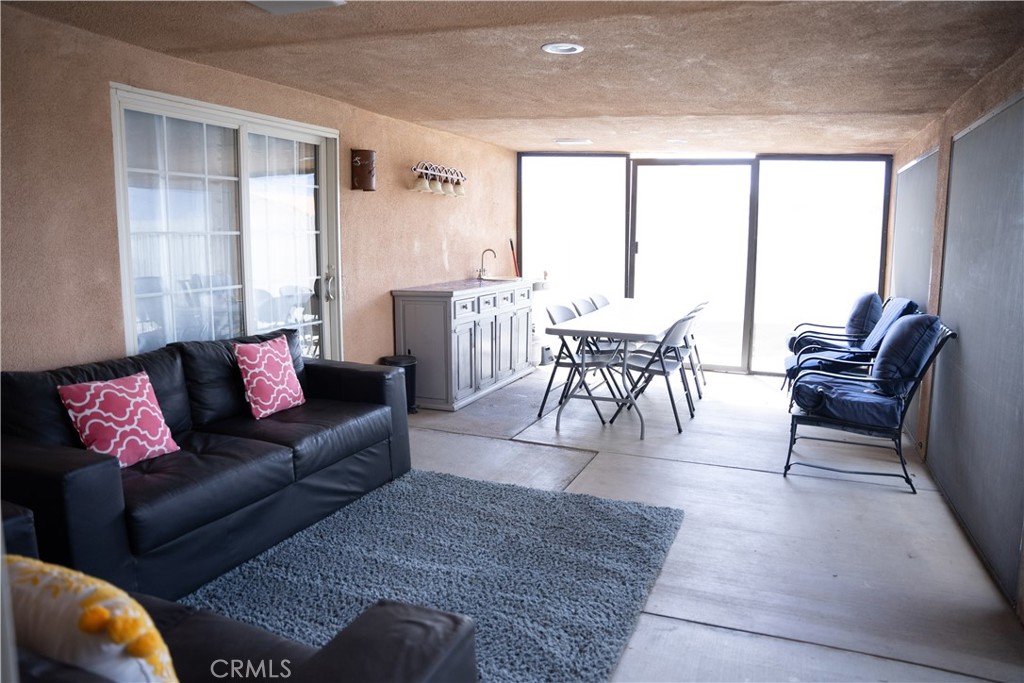 13655 El Rio Lane Desert Hot Springs, CA 92240 - Photo 27 of 27 a living room with furniture and large windows