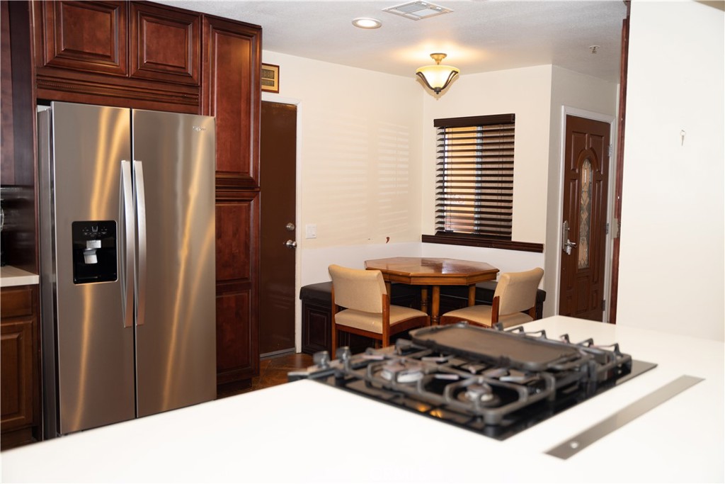 13655 El Rio Lane Desert Hot Springs, CA 92240 - Photo 3 of 27 a kitchen with stainless steel appliances a refrigerator and microwave