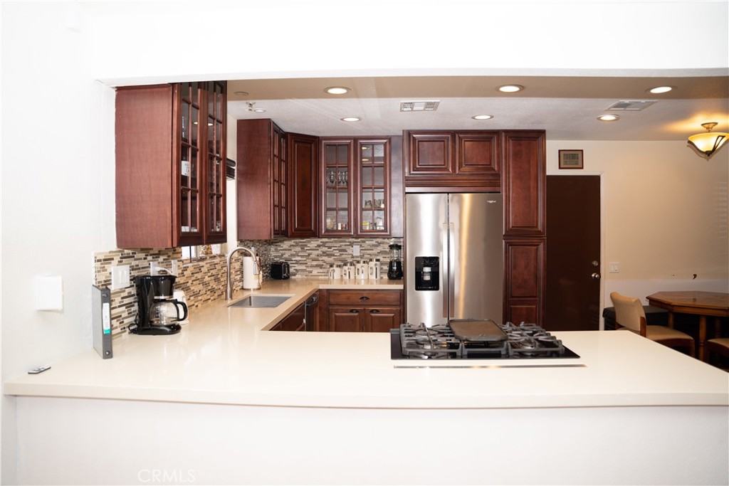 13655 El Rio Lane Desert Hot Springs, CA 92240 - Photo 4 of 27 a kitchen with a refrigerator and a sink