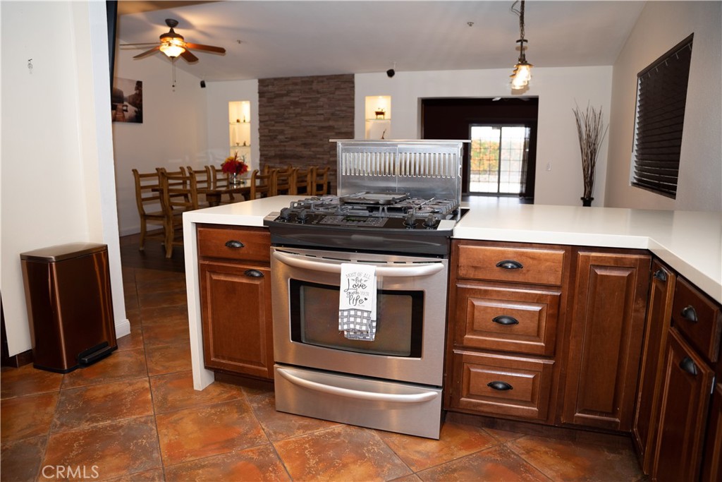 13655 El Rio Lane Desert Hot Springs, CA 92240 - Photo 5 of 27 a kitchen with a stove and a microwave