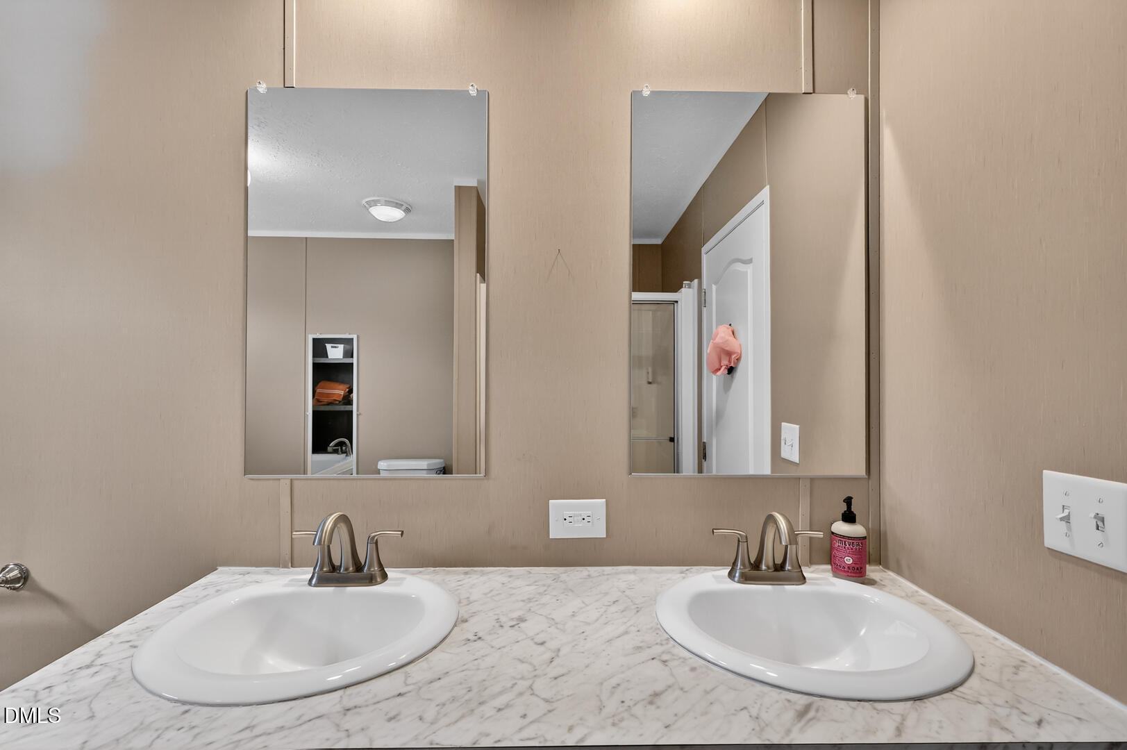 540 Pine Ridge Road Zebulon, NC 27597 - Photo 68 of 96 a bathroom with double vanity sinks and a mirror