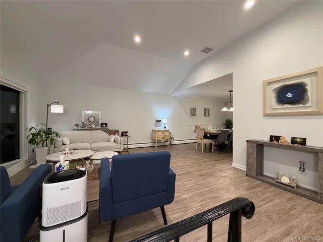 a living room with lots of furniture and kitchen view