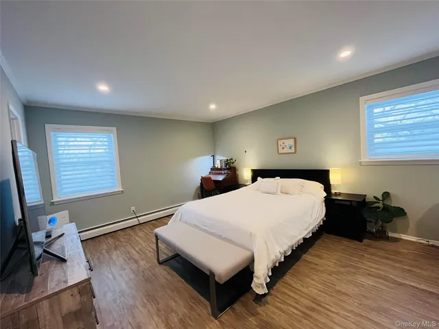 a bed room with a bed window and a dresser