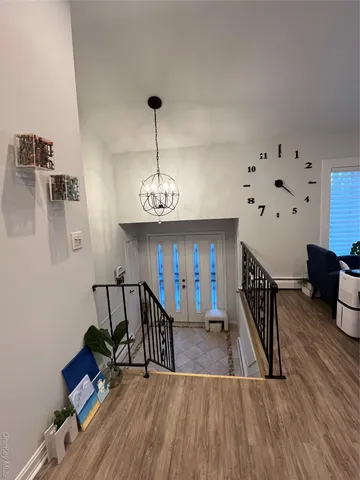 a view of a room with furniture and wooden floor