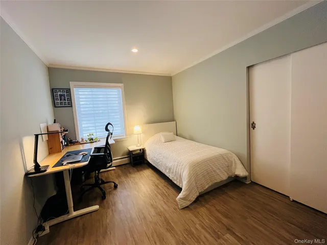 a bedroom with a bed and a desk