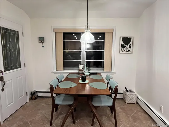 a dining room with furniture and window