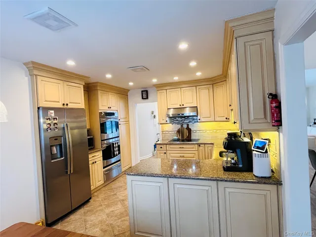 a kitchen with refrigerator and cabinets