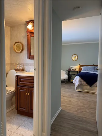 a bedroom with a bed and a mirror