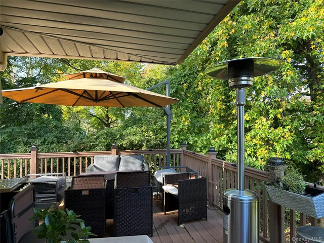a view of a deck with furniture and a yard