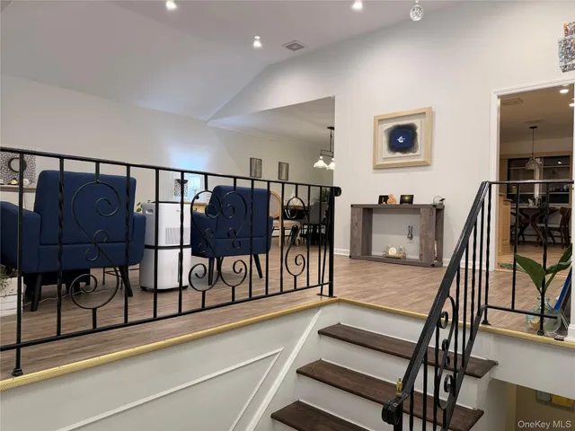 a view of entryway livingroom and hall with wooden floor
