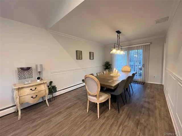 a dining room with furniture and wooden floor