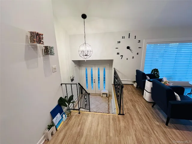 a view of a livingroom with furniture wooden floor windows