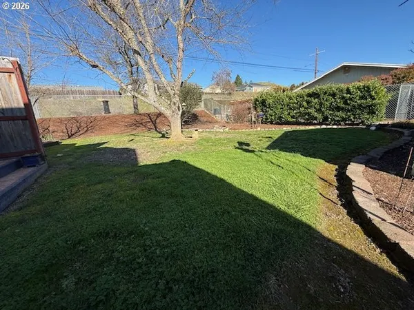 a view of a garden with a house