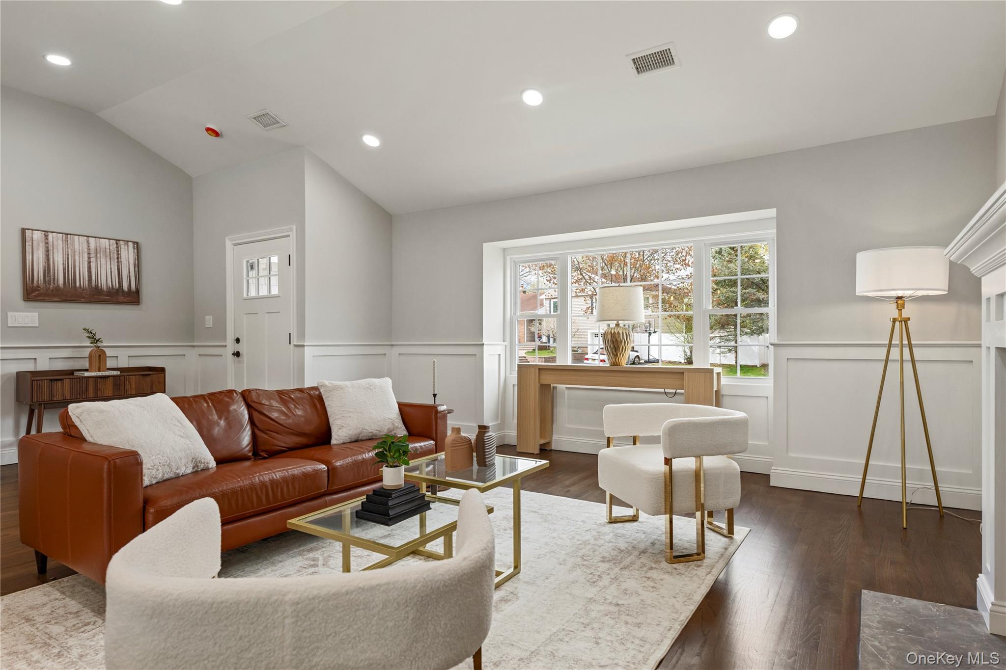 16 Eleanor Road Plainview, NY 11803 - Photo 3 of 28 Spacious living area featuring dark wood-finish flooring, white wainscoting, recessed lighting, andlarge picture window