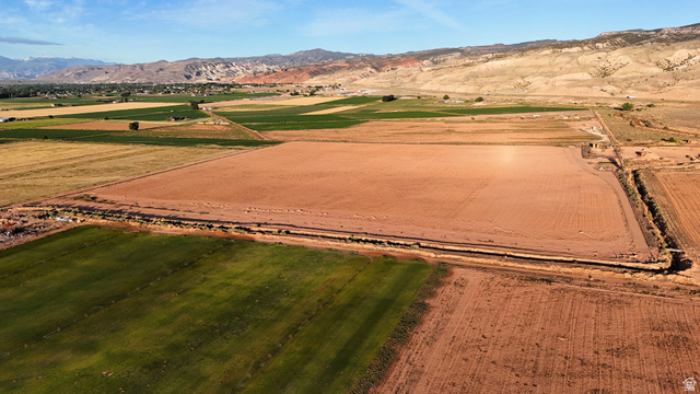 1000 East Mink Farm Road Richfield, UT 84701 - Photo 9 of 29 Expansive land parcel featuring prepared earth, surrounding cultivated fields, and distant mountain backdrops