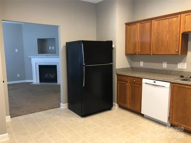 a kitchen with a refrigerator and cabinets