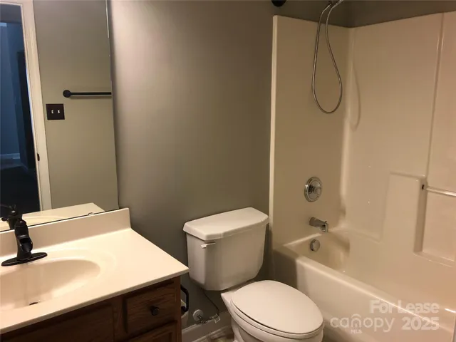 a white toilet sitting next to a bath tub