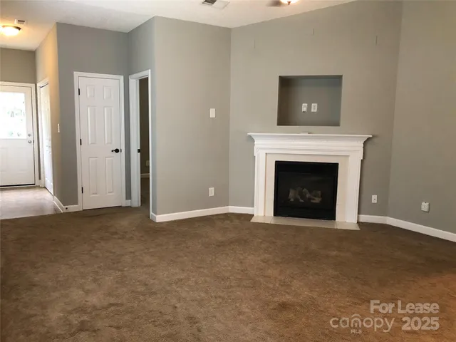 a view of an empty room with a fireplace