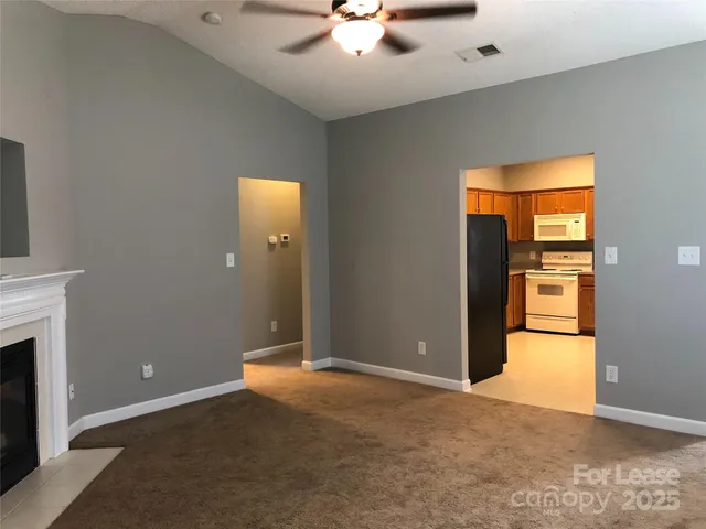 an empty room with closet and a fireplace