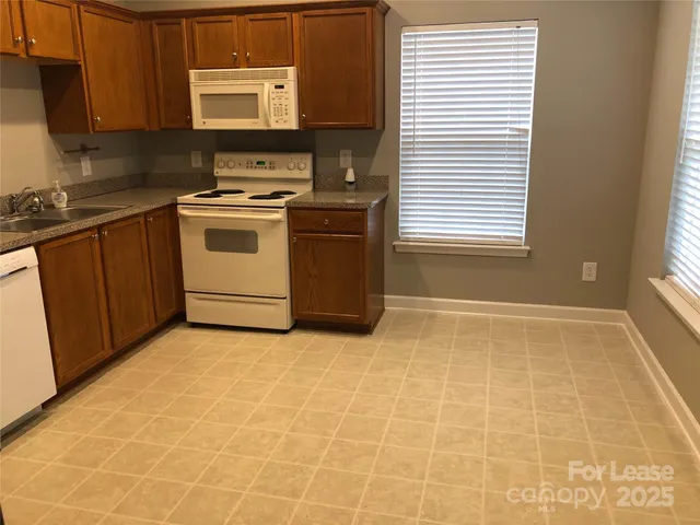 a kitchen with a stove a sink and a cabinets