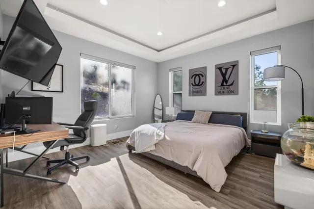 a bedroom with a bed and a flat screen tv