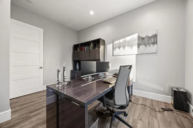 a spacious bedroom with a large bed and a chandelier