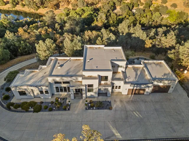 an aerial view of a house with yard swimming pool and outdoor seating