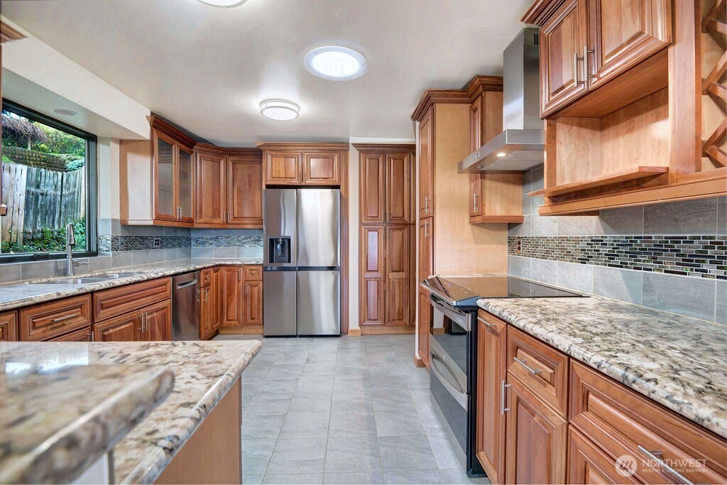 4322 29th Avenue West Seattle, WA 98199 - Photo 11 of 39 a kitchen with stainless steel appliances granite countertop a sink stove and refrigerator