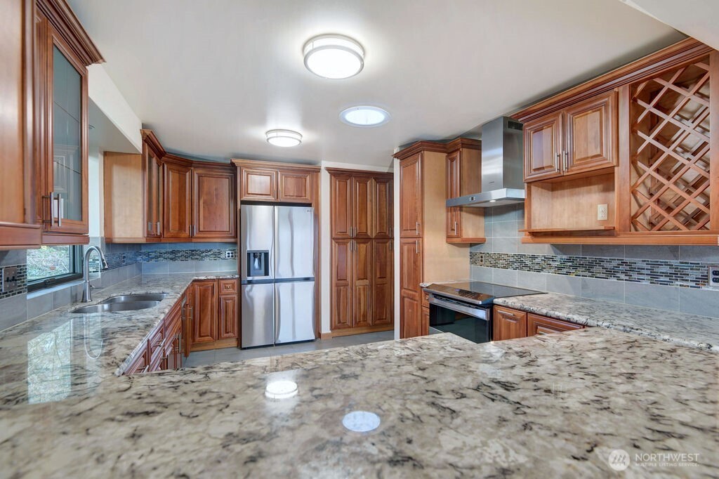 4322 29th Avenue West Seattle, WA 98199 - Photo 12 of 39 a kitchen with stainless steel appliances granite countertop a refrigerator and a sink
