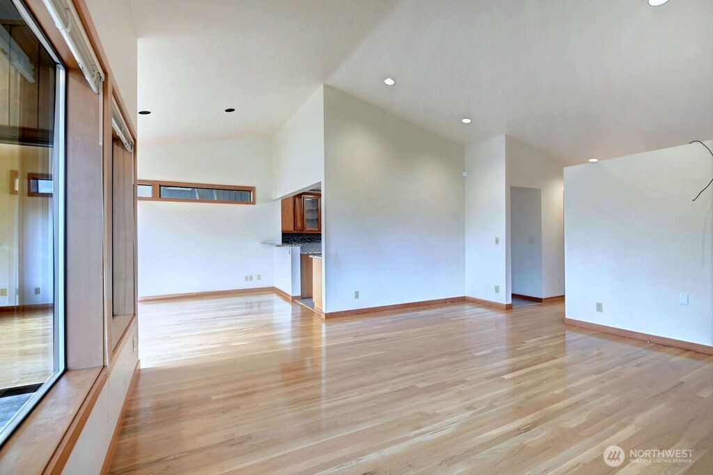 4322 29th Avenue West Seattle, WA 98199 - Photo 17 of 39 a view of an empty room with wooden floor