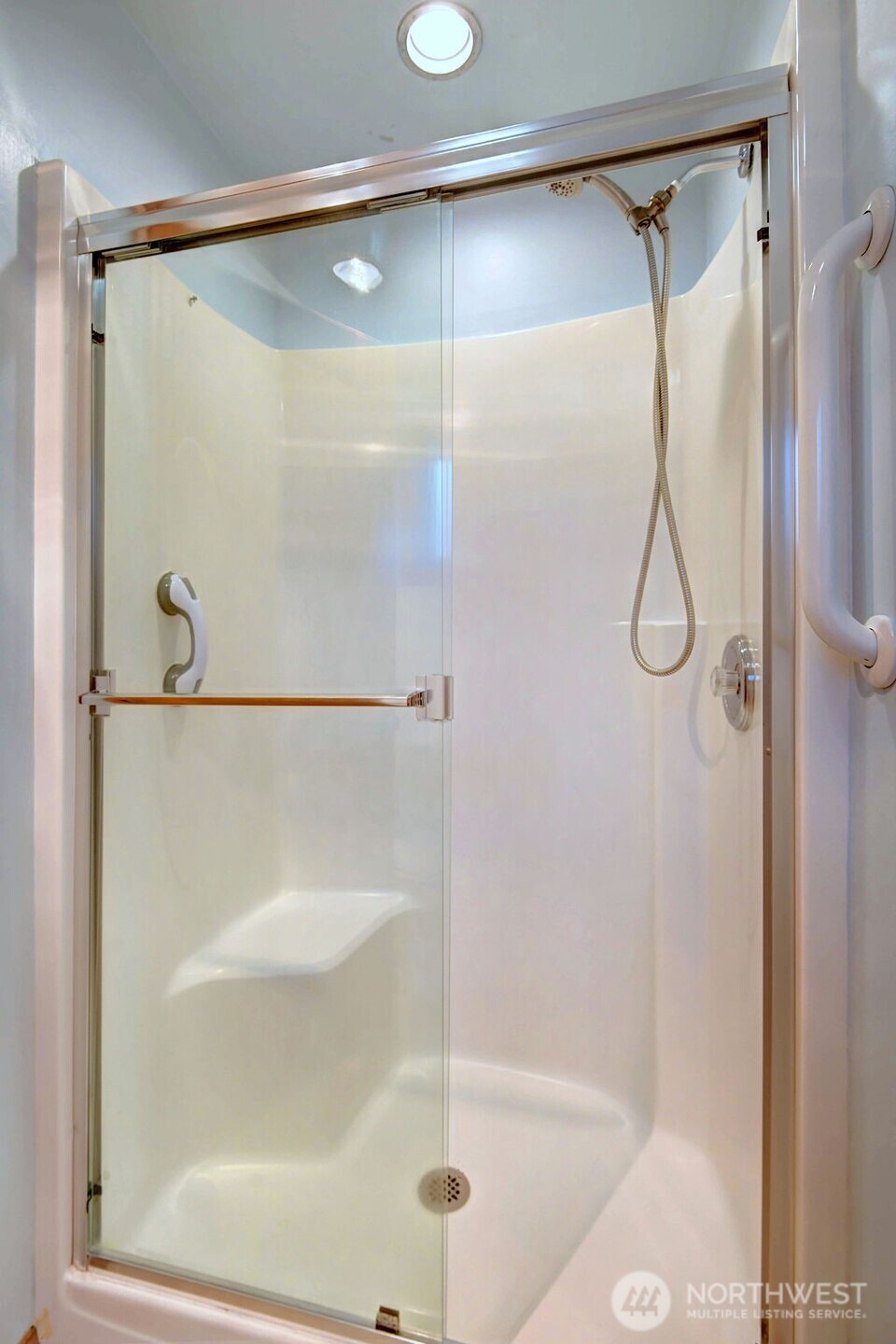 4322 29th Avenue West Seattle, WA 98199 - Photo 23 of 39 a bathroom with a glass shower door