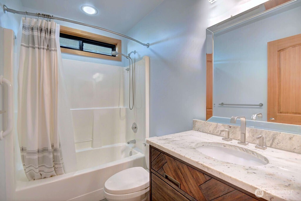 4322 29th Avenue West Seattle, WA 98199 - Photo 32 of 39 a bathroom with a granite countertop sink toilet and shower