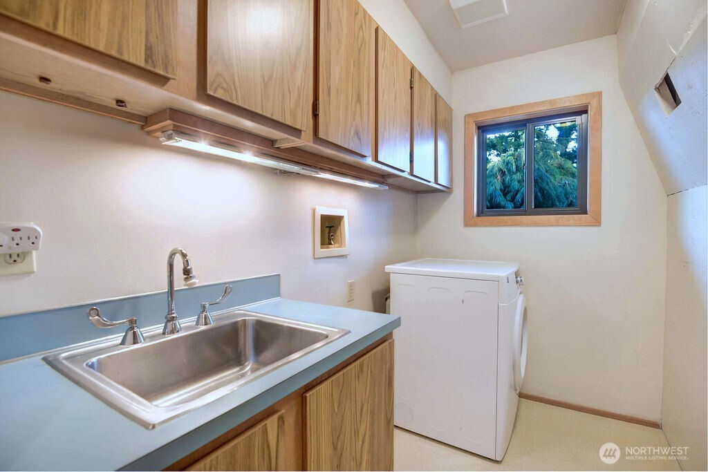 4322 29th Avenue West Seattle, WA 98199 - Photo 33 of 39 a kitchen with a sink cabinets and a wooden floor