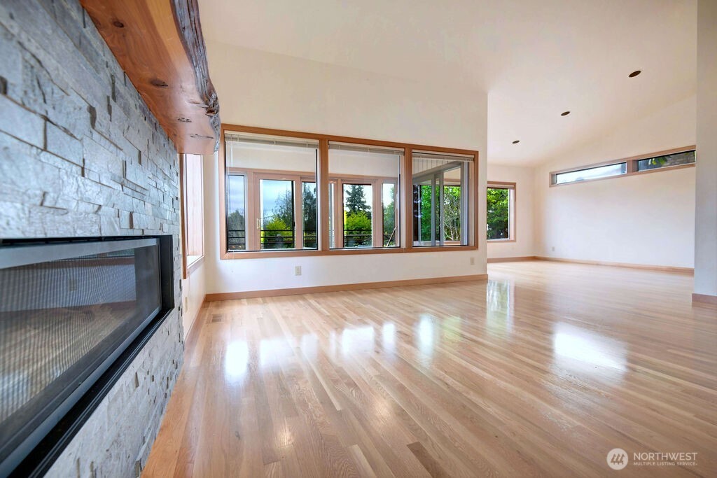 4322 29th Avenue West Seattle, WA 98199 - Photo 6 of 39 wooden floor in an empty room with a fireplace