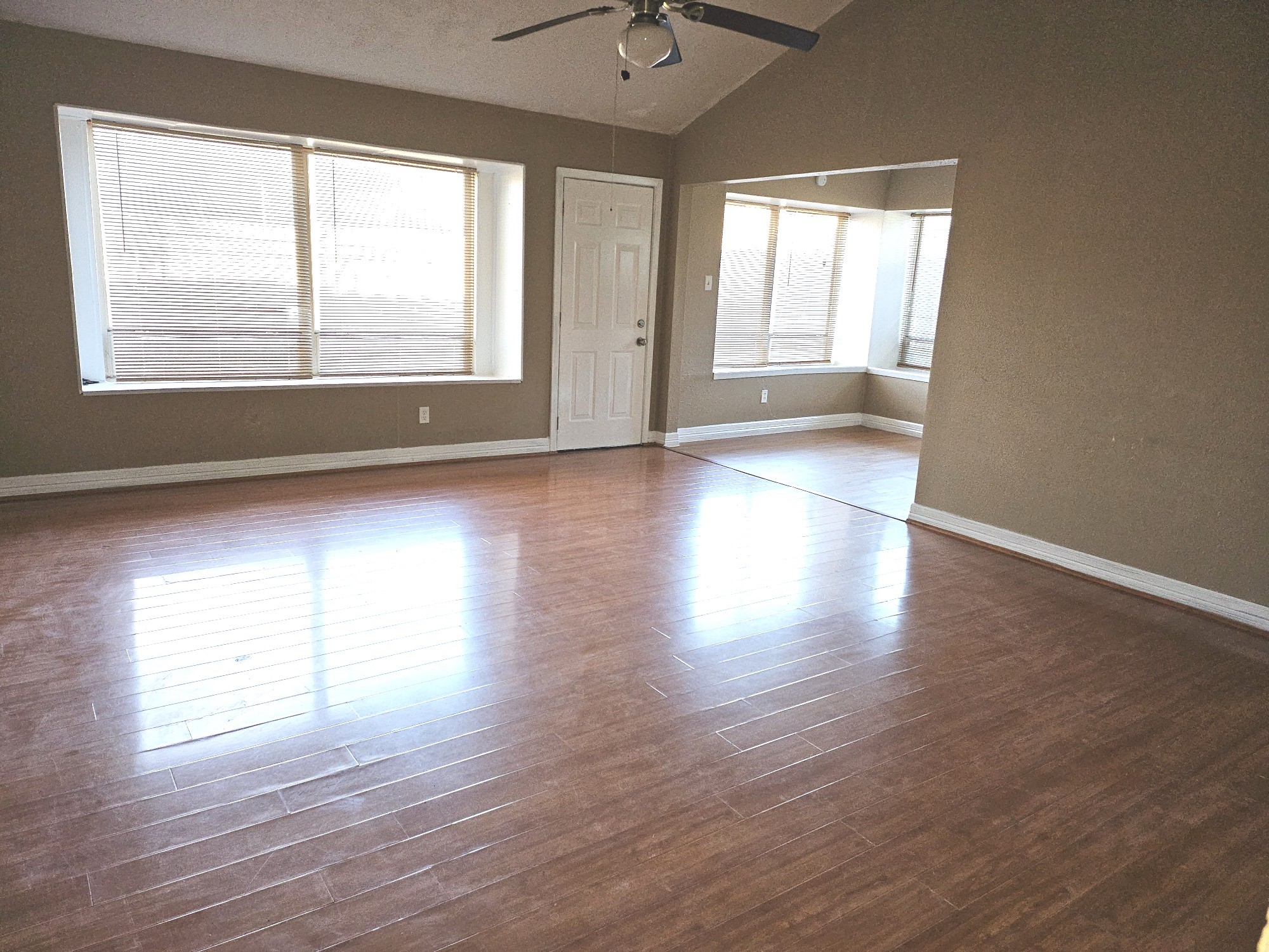 15829 Ridgeroe Lane Houston, TX 77053 - Photo 4 of 15 a view of an empty room with wooden floor and a window