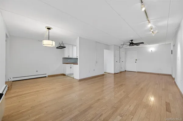 an empty room with an empty space and wooden floor