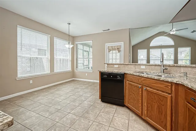 a large kitchen with granite countertop a sink and a stove