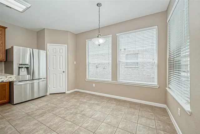 a view of a kitchen with a dishwasher cabinets and a window