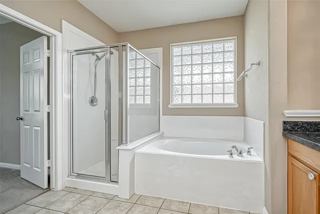 a bathroom with a bathtub and a shower