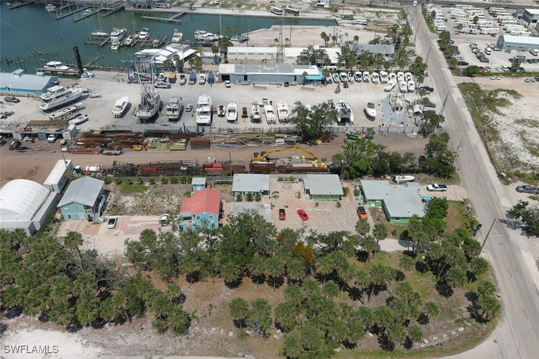 1180 Main Street, Unit 6 Fort Myers Beach, FL 33931 - Photo 2 of 18 an aerial view of a residential houses with outdoor space