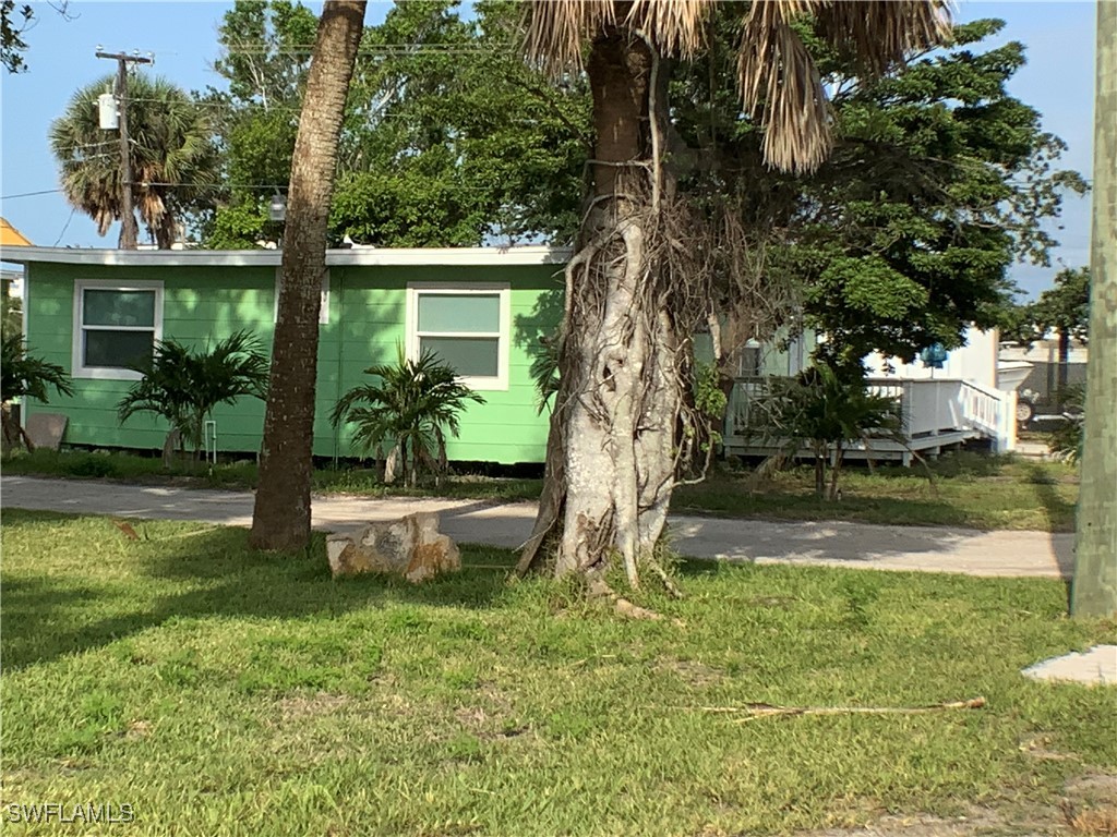 1180 Main Street, Unit 6 Fort Myers Beach, FL 33931 - Photo 10 of 18 a view of a house with backyard and sitting area