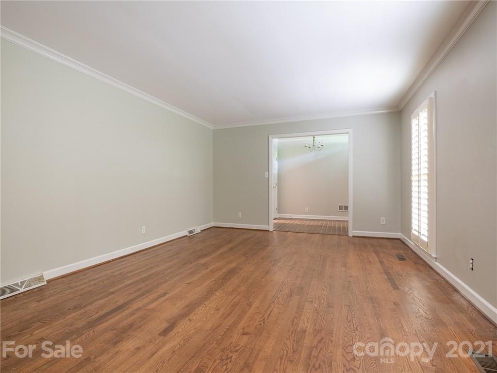 925 Reverdy Lane Matthews, NC 28105 - Photo 2 of 36 an empty room with wooden floor and windows