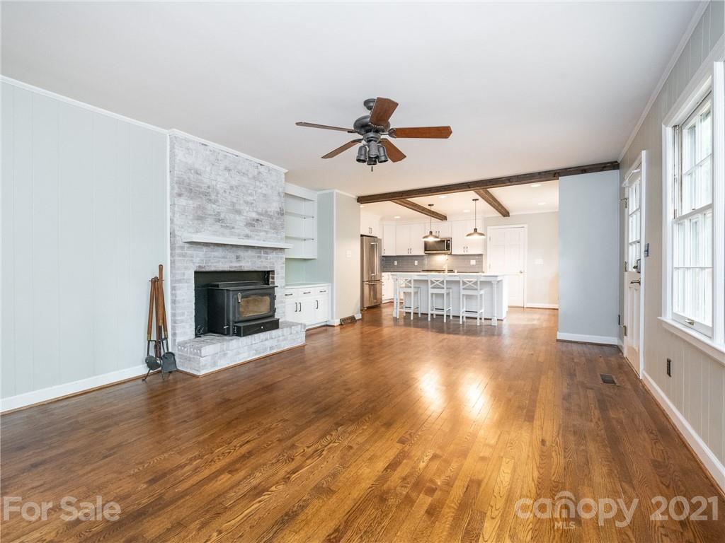 925 Reverdy Lane Matthews, NC 28105 - Photo 13 of 36 an empty room with wooden floor fireplace and windows