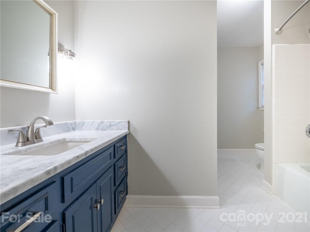 925 Reverdy Lane Matthews, NC 28105 - Photo 19 of 36 a bathroom with a granite countertop sink and a mirror