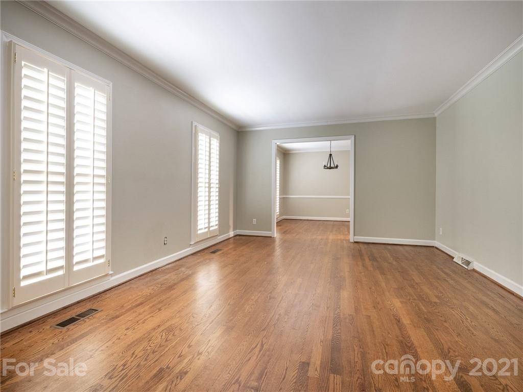 925 Reverdy Lane Matthews, NC 28105 - Photo 3 of 36 an empty room with wooden floor and windows