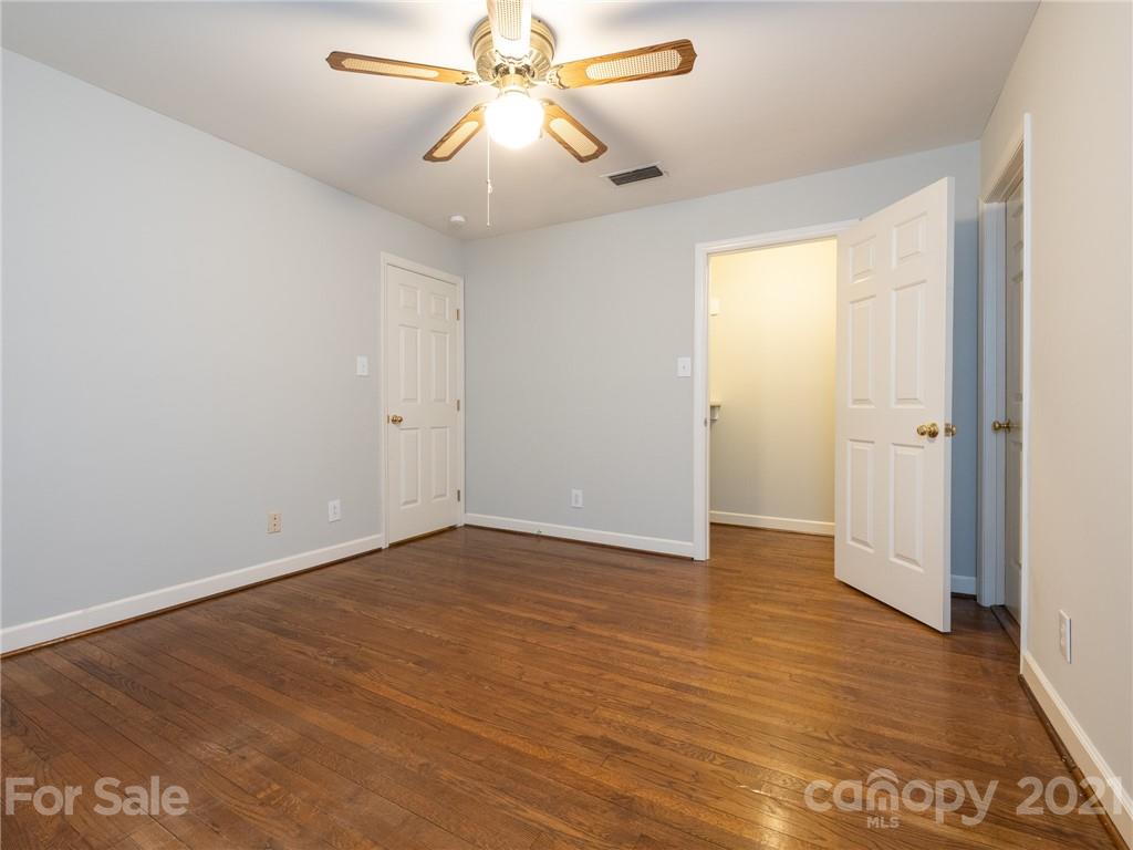 925 Reverdy Lane Matthews, NC 28105 - Photo 23 of 36 an empty room with wooden floor and windows
