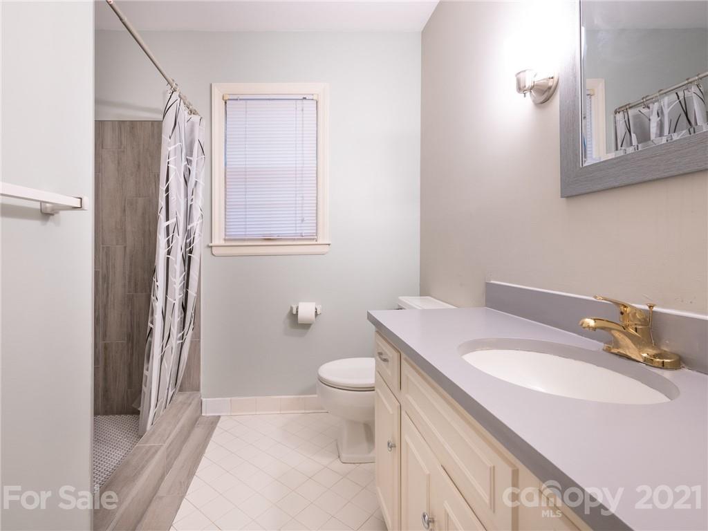 925 Reverdy Lane Matthews, NC 28105 - Photo 24 of 36 a bathroom with a granite countertop sink toilet and shower